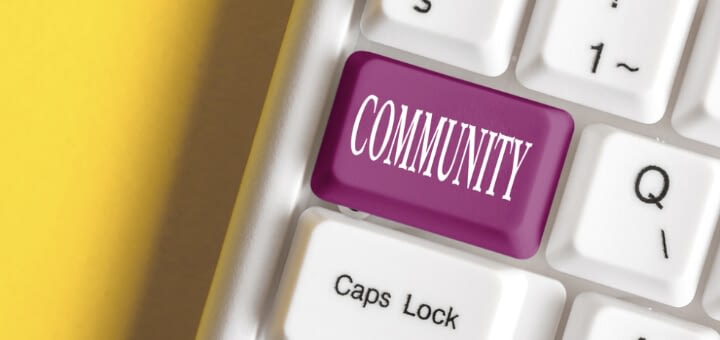 keyboard with key that says community on yellow background, conceptual image for blogging community